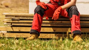 Unrecognizable,Person,On,Construction,Site,Wearing,Protective,Worker,Red,Black